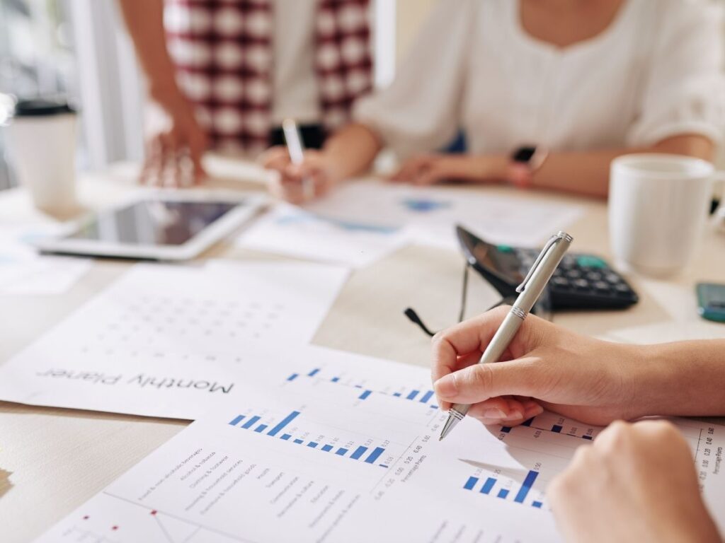 A manager reviewing CVs while also checking training logs or payroll reports