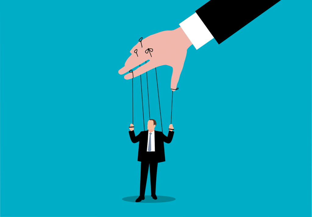 Large hand controlling businessman like puppet