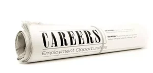 Rolled-up newspaper with the headline 'Careers' and 'Employment Opportunities
