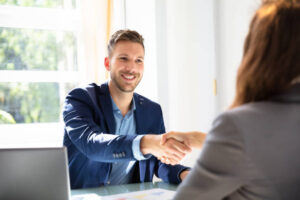 Smiling Young Businessman Shaking Hands With His Partner