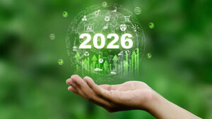 An open hand holds a digital globe featuring the year "2026" and green growth charts.