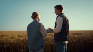 Agronomists team working wheat field together.
