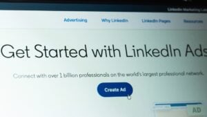 A close-up shot of a computer screen showing the "Get Started with LinkedIn Ads" page with a blue "Create Ad" button.